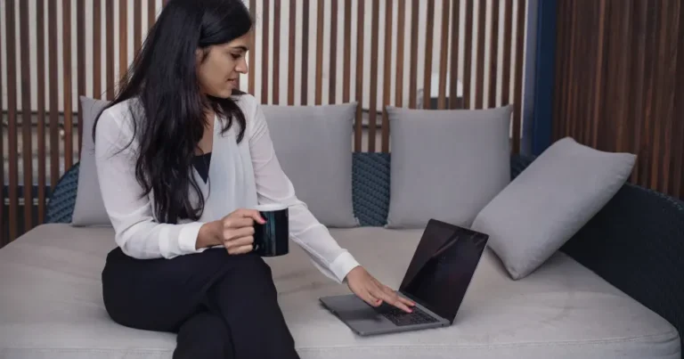 Small business owner writing a marketing email on a laptop
