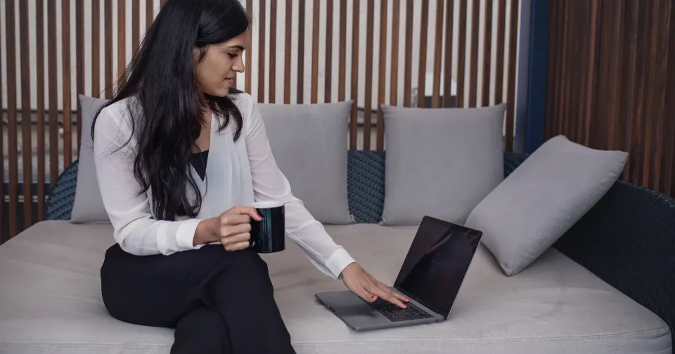 Small business owner writing a marketing email on a laptop