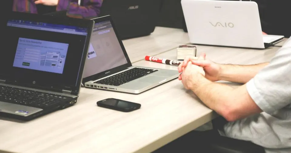 Local business owners collaborating on laptops