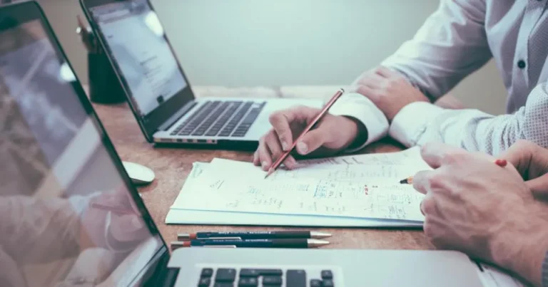 Business owner writing homepage copy next to a laptop