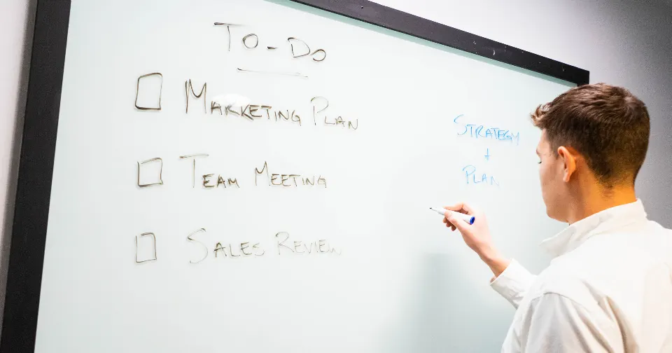 Marketer planning SEO and advertising strategy on a whiteboard