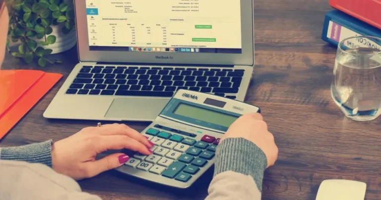 Business owner calculating website budget on a laptop