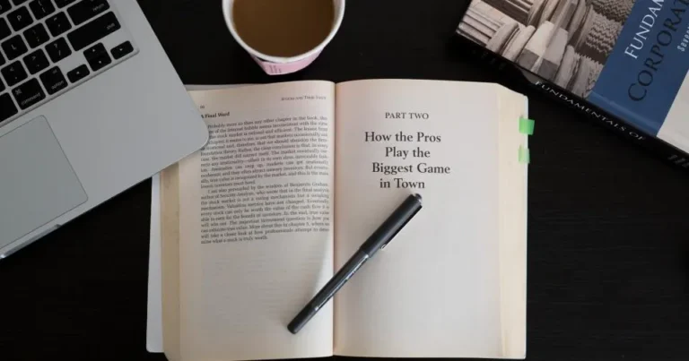 Laptop and open book on a desk representing accessible website content